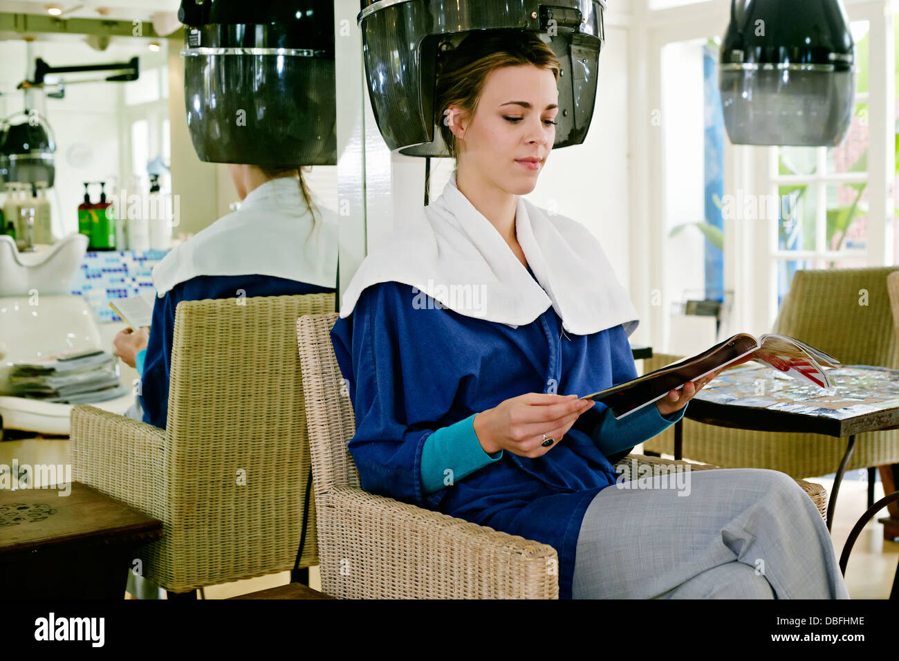 Caucasian woman having hair done in salon Stock Photo