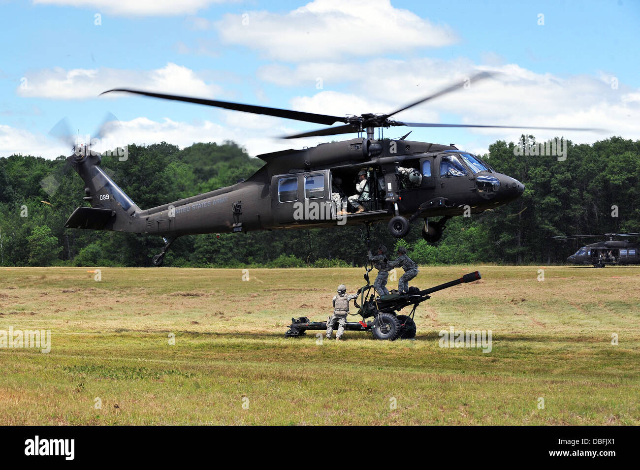 The crew of a 105-mm howitzer sling-loads their cannon to a Black Hawk helicopter as part of a combined arms training exercise July 23 at Fort McCoy, Wis. Three Wisconsin National Guard battalions -- the 1st Battalion, 147th Aviation Regiment, 2nd Battali Stock Photo
