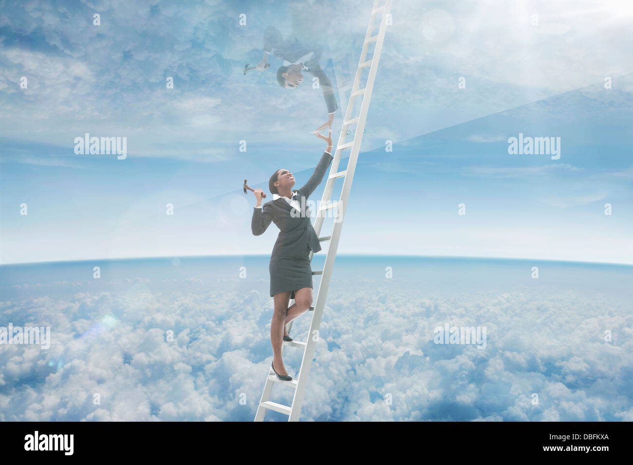 African American businesswoman on ladder to glass ceiling Stock Photo