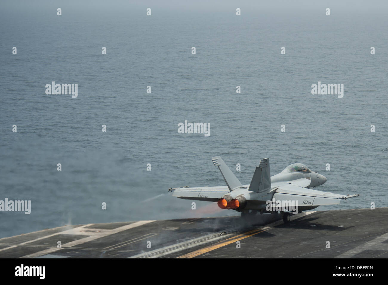 F/A-18F Super Hornet assigned to the Black Knights of Strike Fighter Squadron (VFA) 154 launches from the flight deck of the ai Stock Photo