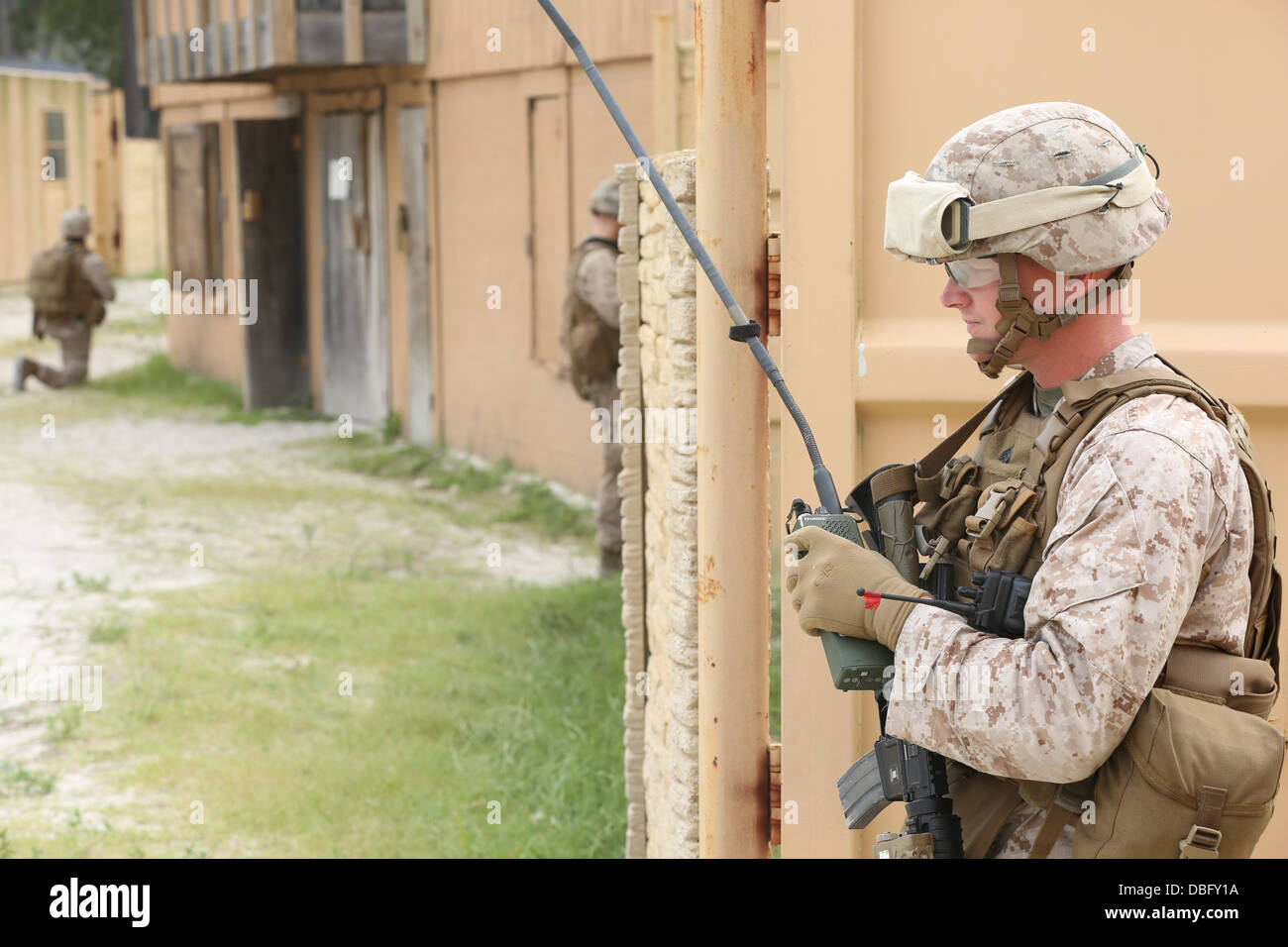 A Marine with 3rd Battalion, 8th Marine Regiment listens to his radio during an amphibious operation training exercise July 24, Stock Photo