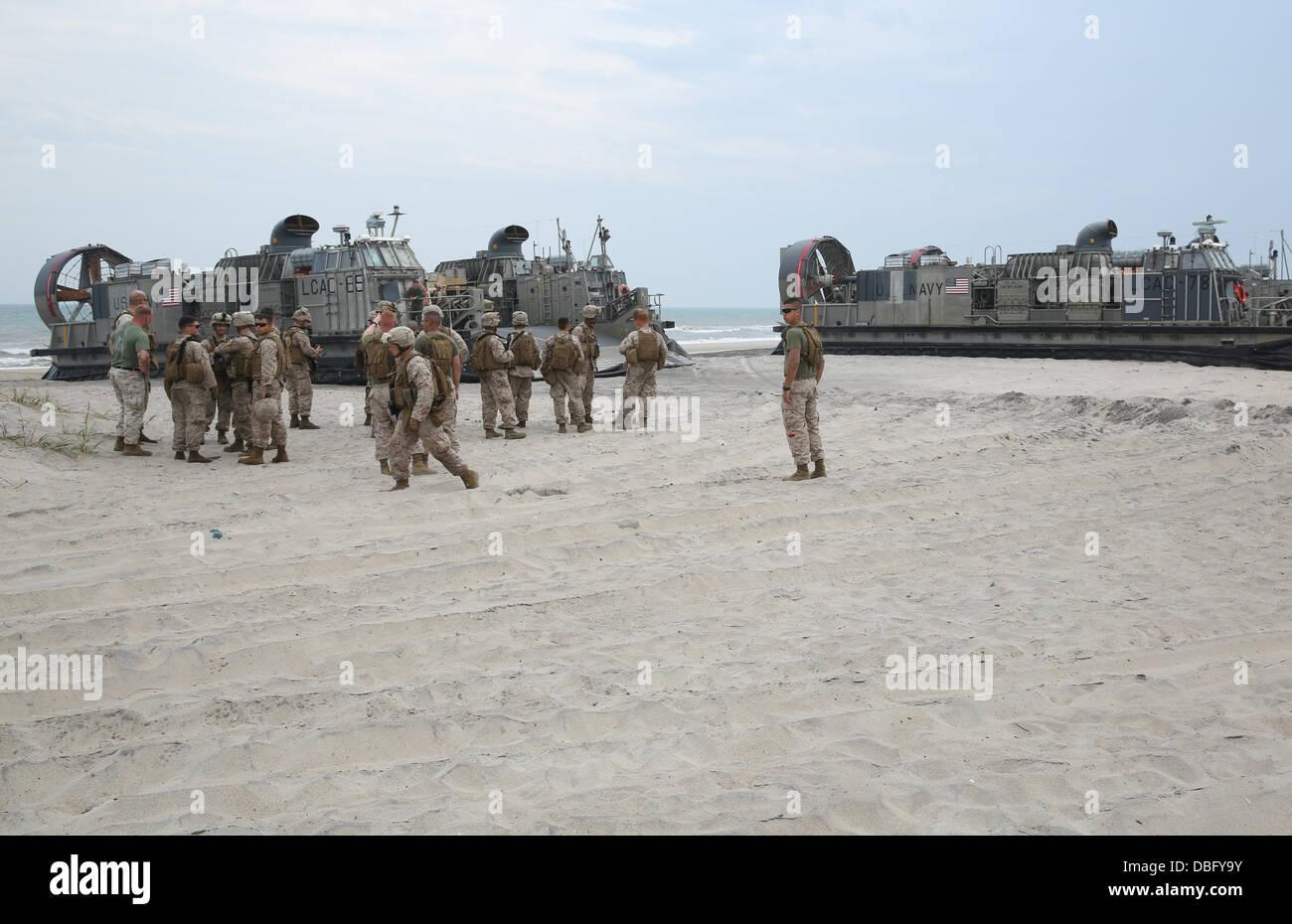 Marines with 3rd Battalion, 8th Marine Regiment, get ready to unload vehicles from landing craft air cushion vehicles during an Stock Photo