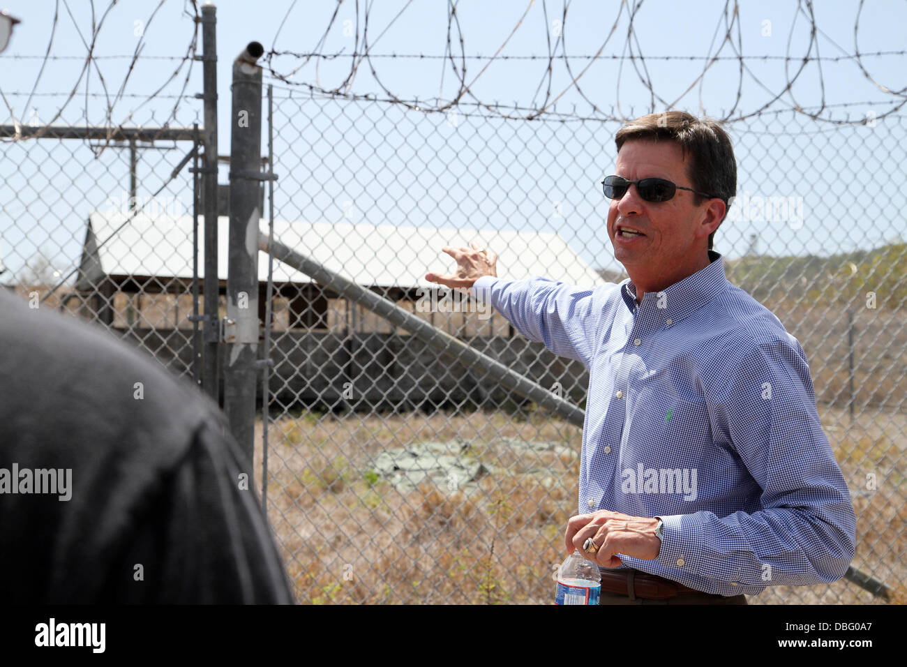 Former Guantanamo Bay prison commander, Ret. Col. Terry Carrico, tours what now remains of Camp X-Ray, July 26, 2013, at U.S. Naval Station Guantanamo Bay, Cuba. Carrico was the first commander of Camp X-Ray when it was established in 2002 as a temporary Stock Photo