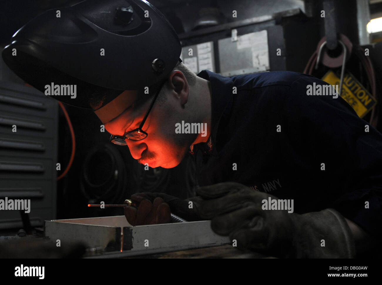 U.S. Navy Hull Maintenance Technician 3rd Class George Weckman welds ...