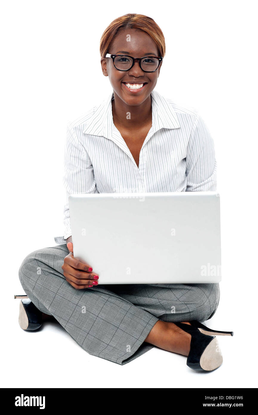 Corporate lady seated on floor working on laptop Stock Photo - Alamy