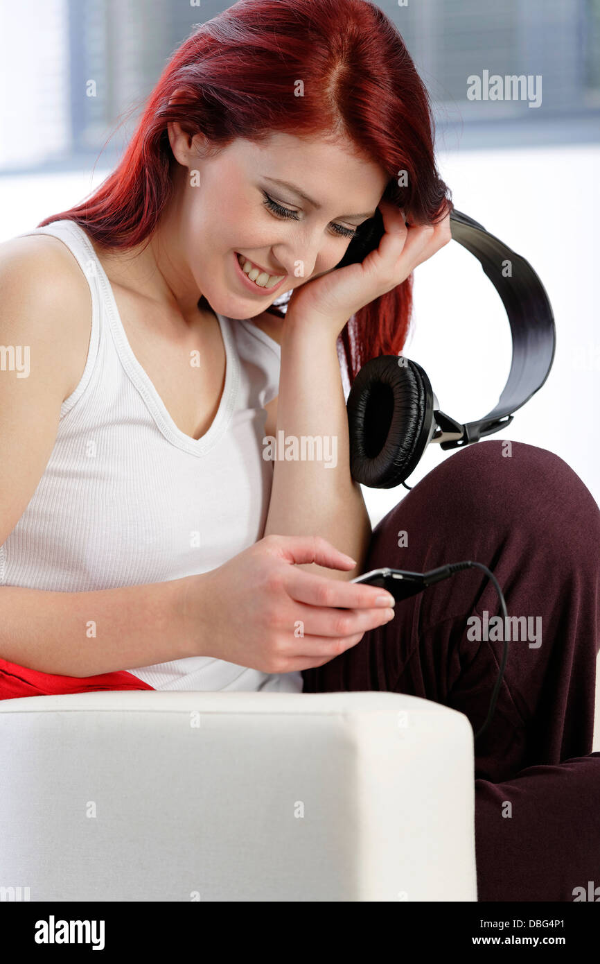 Happy young woman listening to music Stock Photo - Alamy