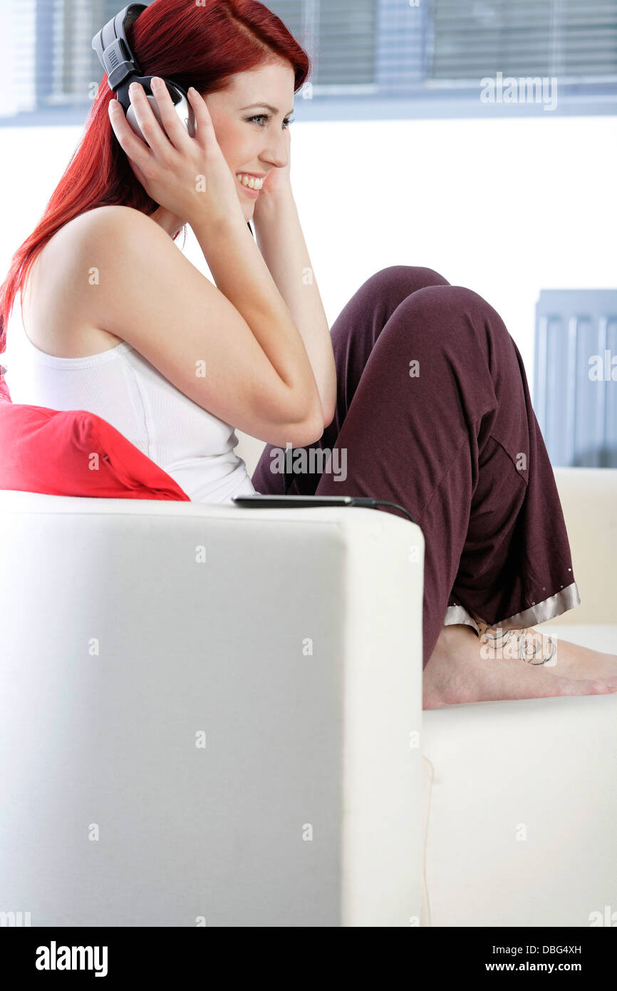 Happy young woman listening to music Stock Photo - Alamy