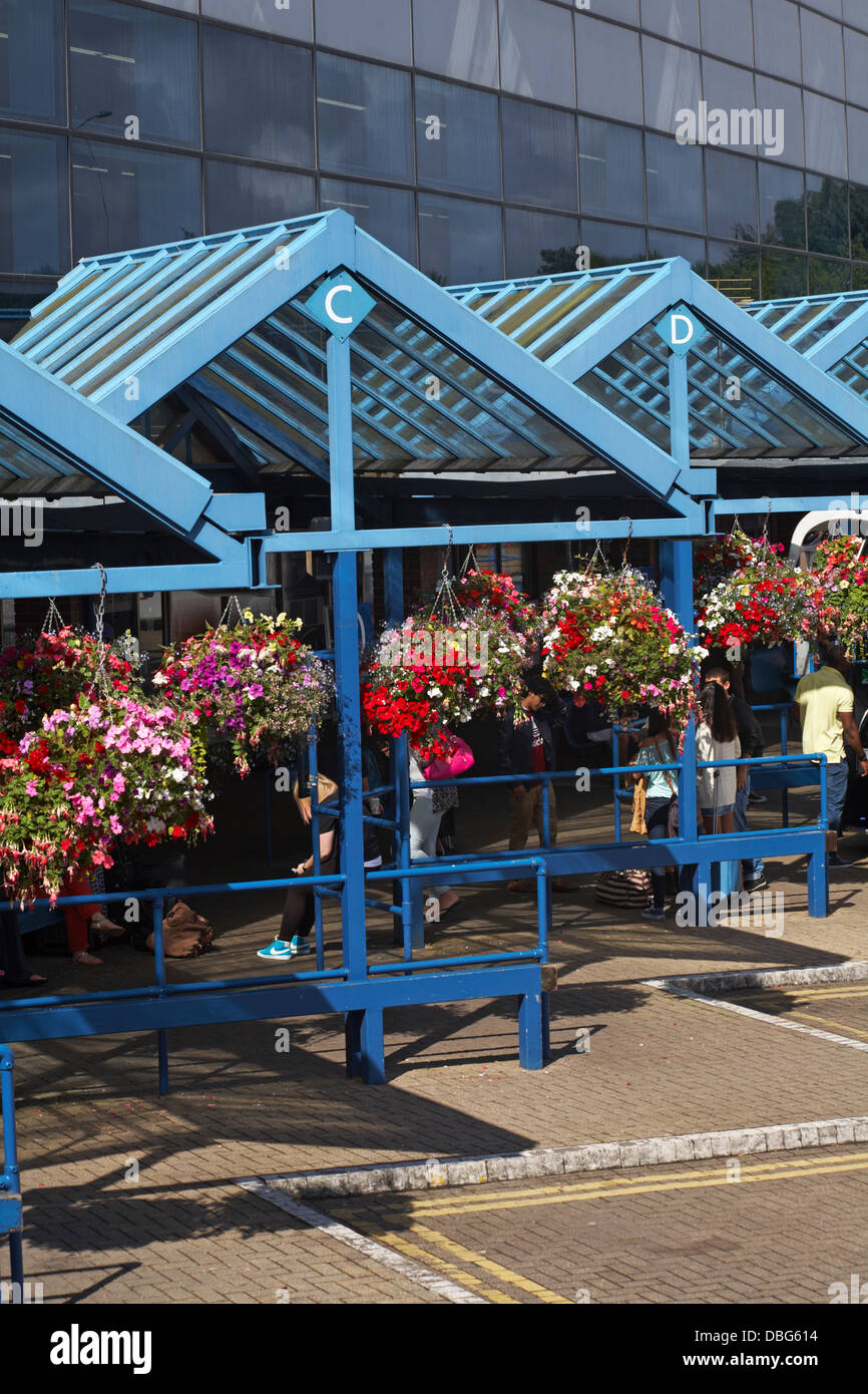 colourful hanging baskets at Bournemouth Coach Station in July Stock