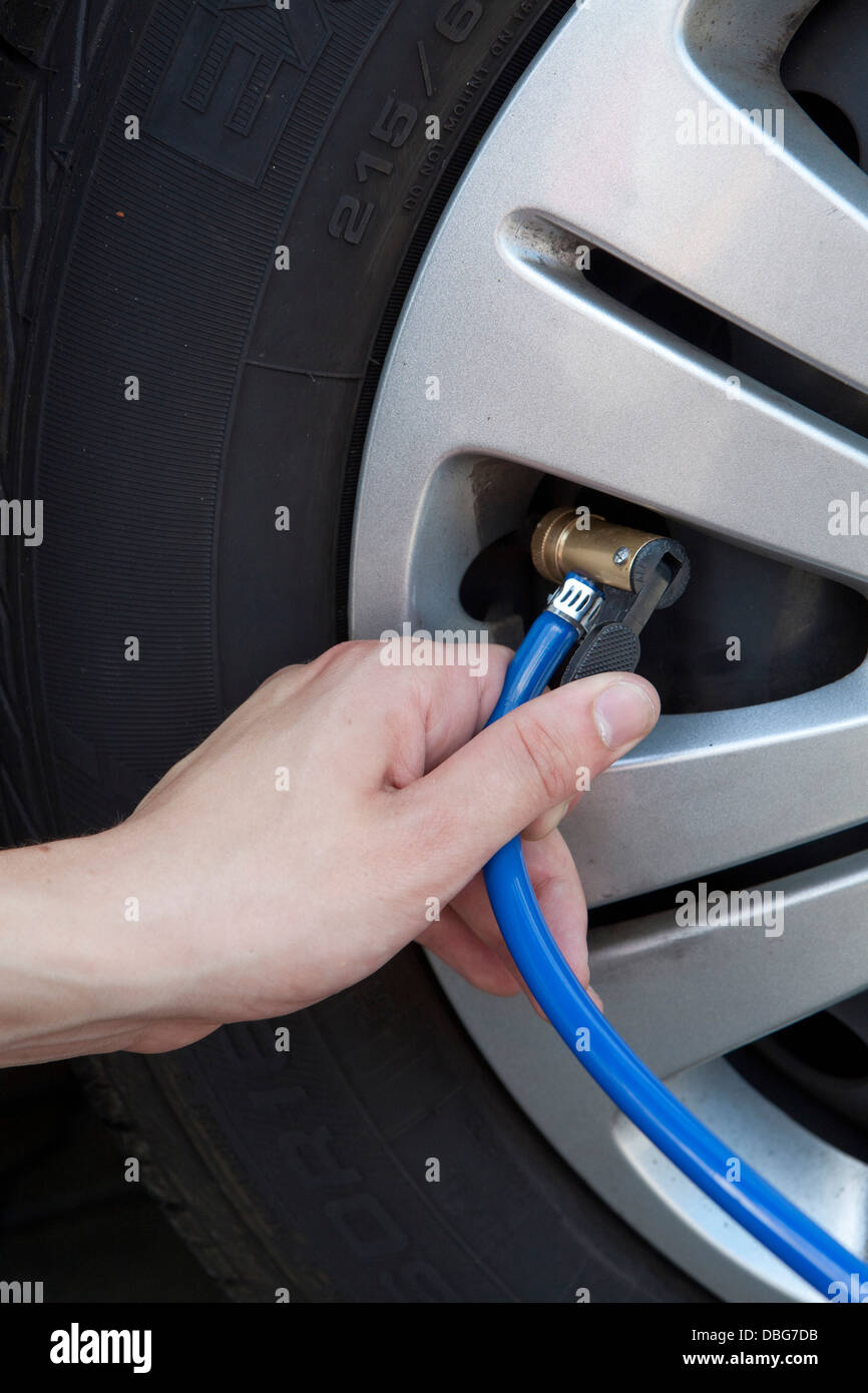 Controll of tire inflation pressure at a car tire Stock Photo