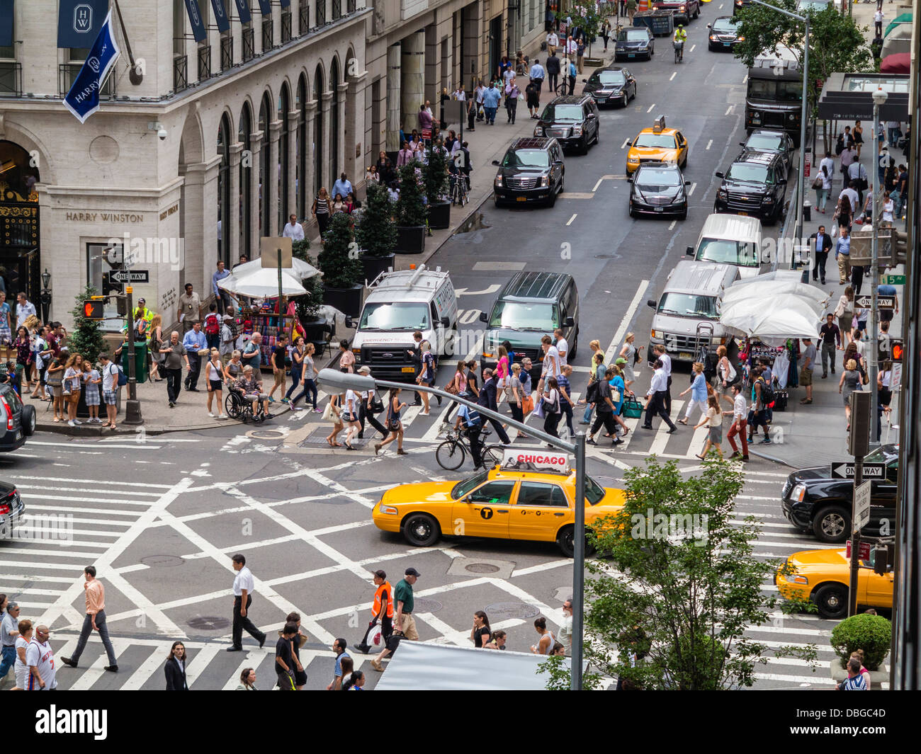 Manhattan, New York street People and traffic at a busy crosswalk highway junction on corner of 5th Avenue in Manhattan, New York City in summer Stock Photo