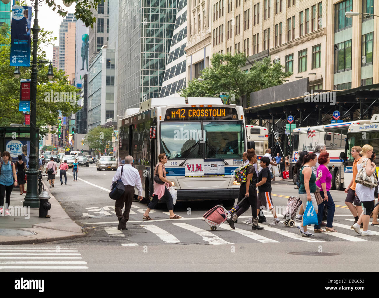 Bus at crosswalk road junction on a city street in Manhattan, New York City Stock Photo
