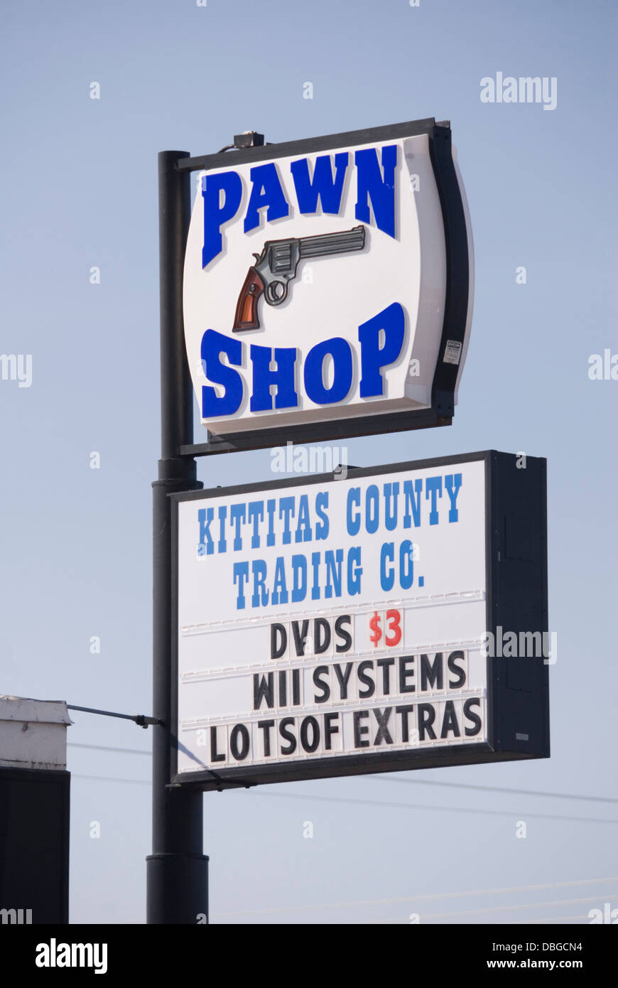 Pawn Shop sign with picture of a gun, advertising cheap Wii systems & DVDs, Ellensburg Trading Co, Ellensburg, Washington, USA Stock Photo