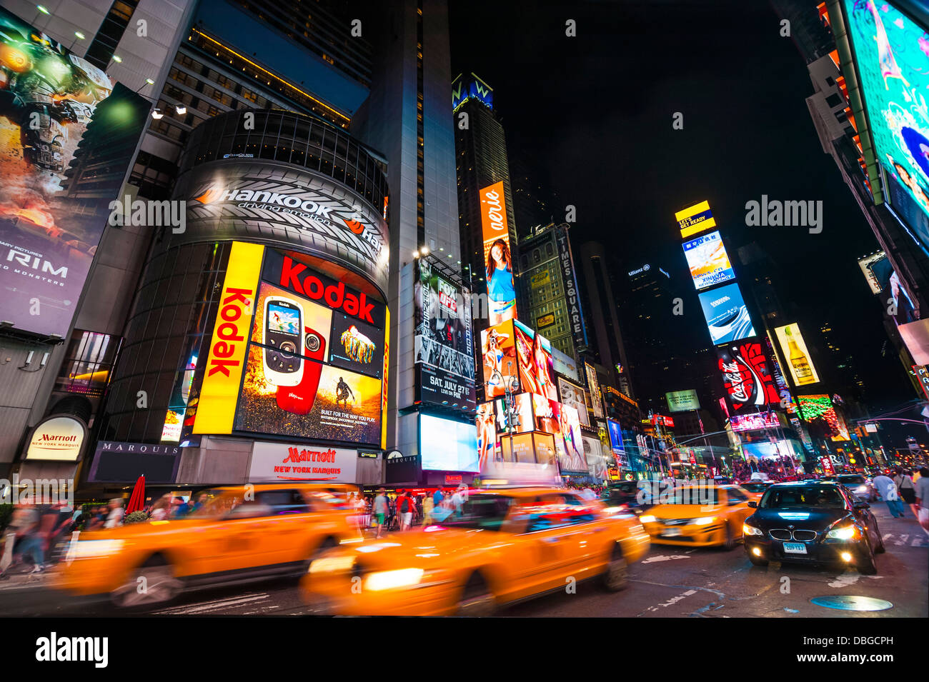 Traffic in Times Square at night with taxi cabs driving through the streets, New York City Stock Photo