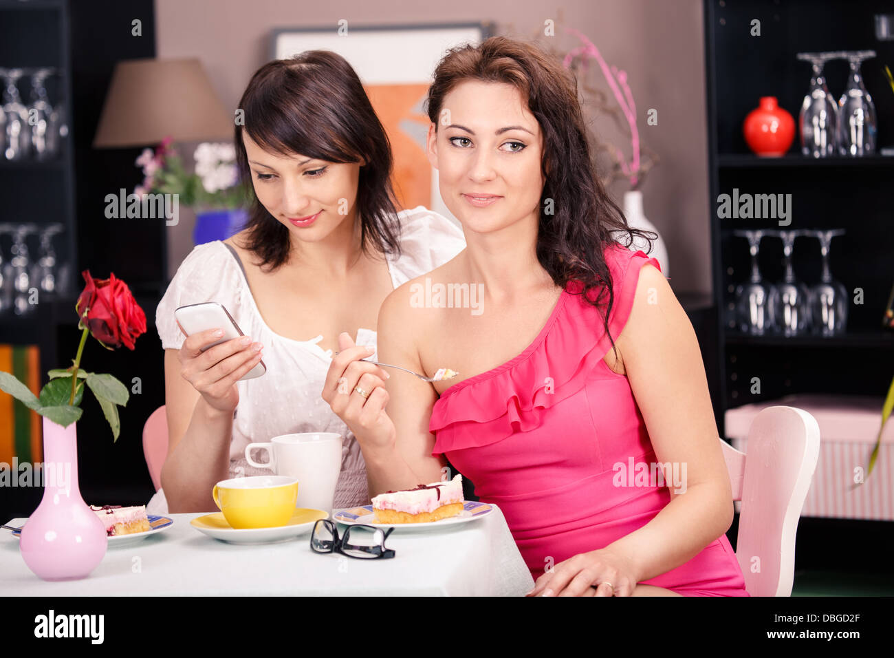portrait of two young women in a cafe Stock Photo - Alamy