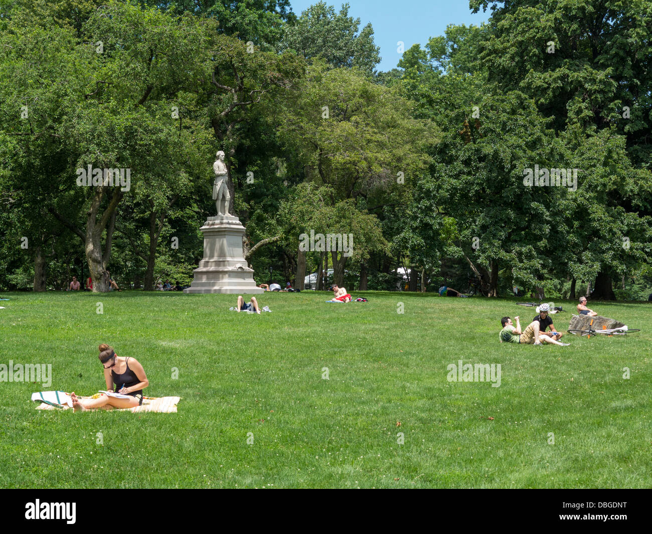 People sunbathing in Central Park, New York City Stock Photo