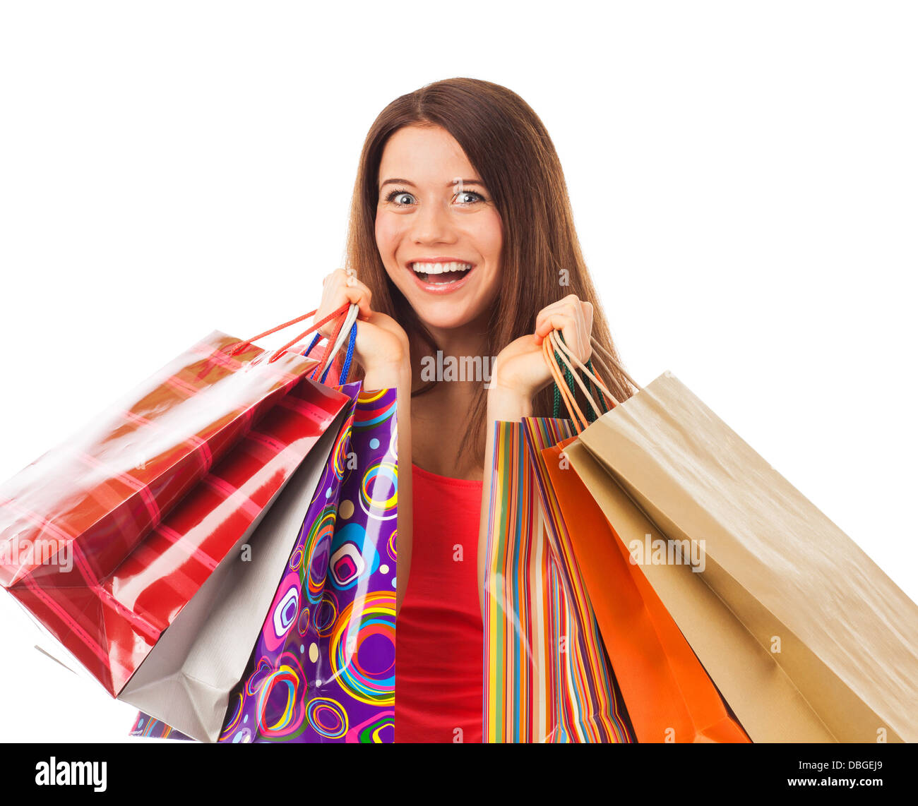 Portrait of a young woman holding shopping bags and looking very happy ...