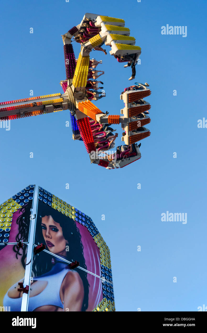 Excited thrillseekers / thrill seekers having fun on the fairground attraction G Force at travelling funfair / traveling fair Stock Photo