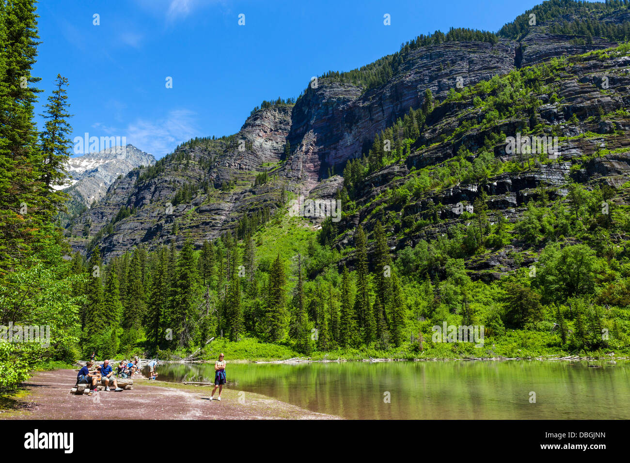 Walkers having a picnic on the shores of Avalanche Lake, Avalanche Lake Trail, Glacier National Park, Montana, USA Stock Photo