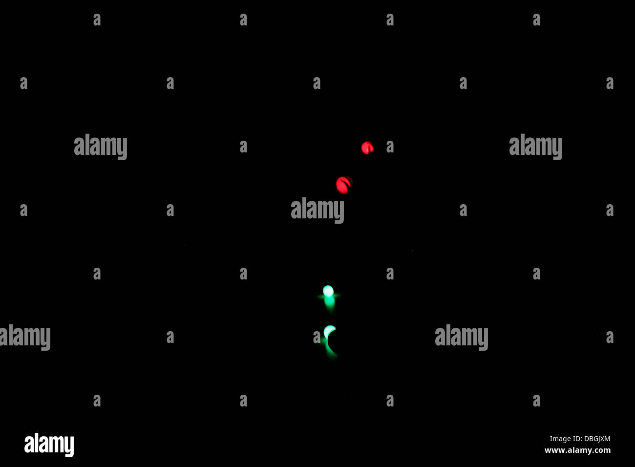 Red and green neon lights on a black background Stock Photo Alamy