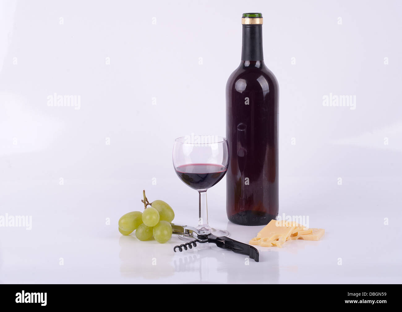 Wine in a glass, a bottle of wine, corkscrew and cheese Stock Photo
