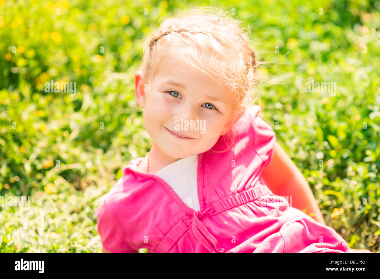 Cute smiling little girl on the meadow in sunny day Stock Photo - Alamy