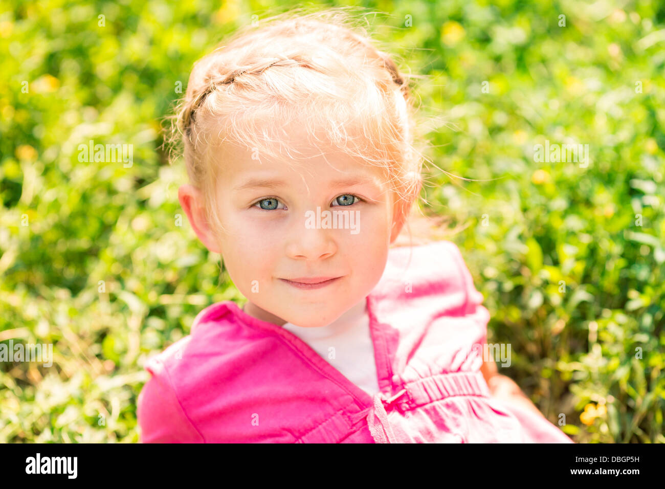 Cute smiling little girl on the meadow in sunny day Stock Photo - Alamy
