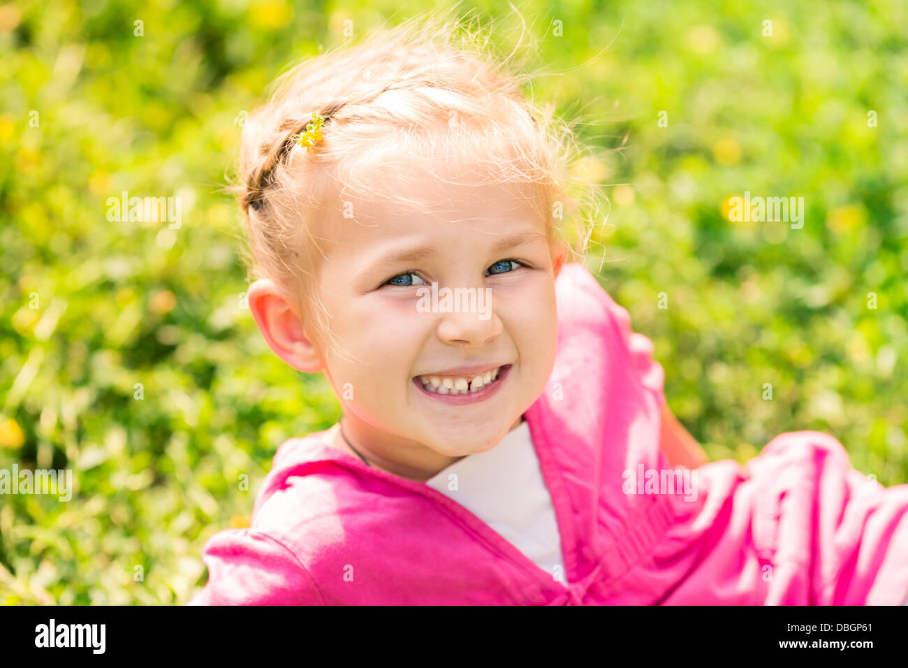 Cute smiling little girl on the meadow in sunny day Stock Photo - Alamy