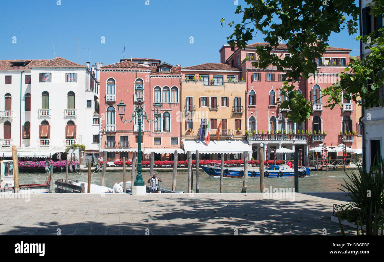A work boat passes along the Grand Canal in front of the Hotel Principe, Venice Stock Photo