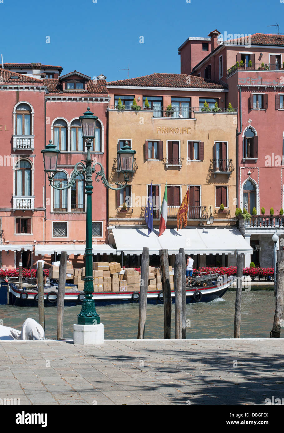 A work boat passes along the Grand Canal in front of the Hotel Principe, Venice Stock Photo