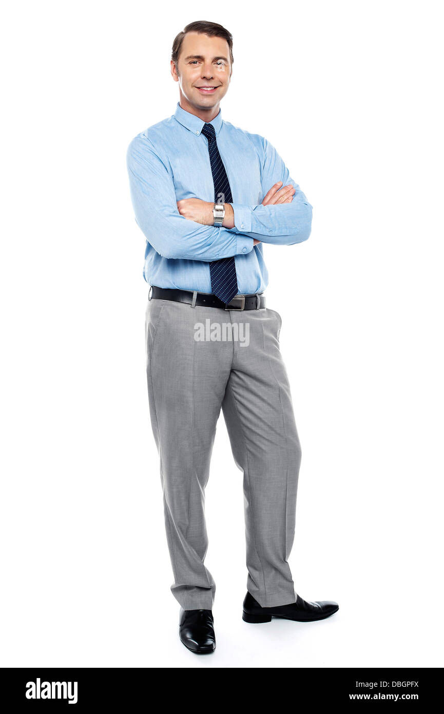 Young team leader smiling confidently with his arms crossed Stock Photo