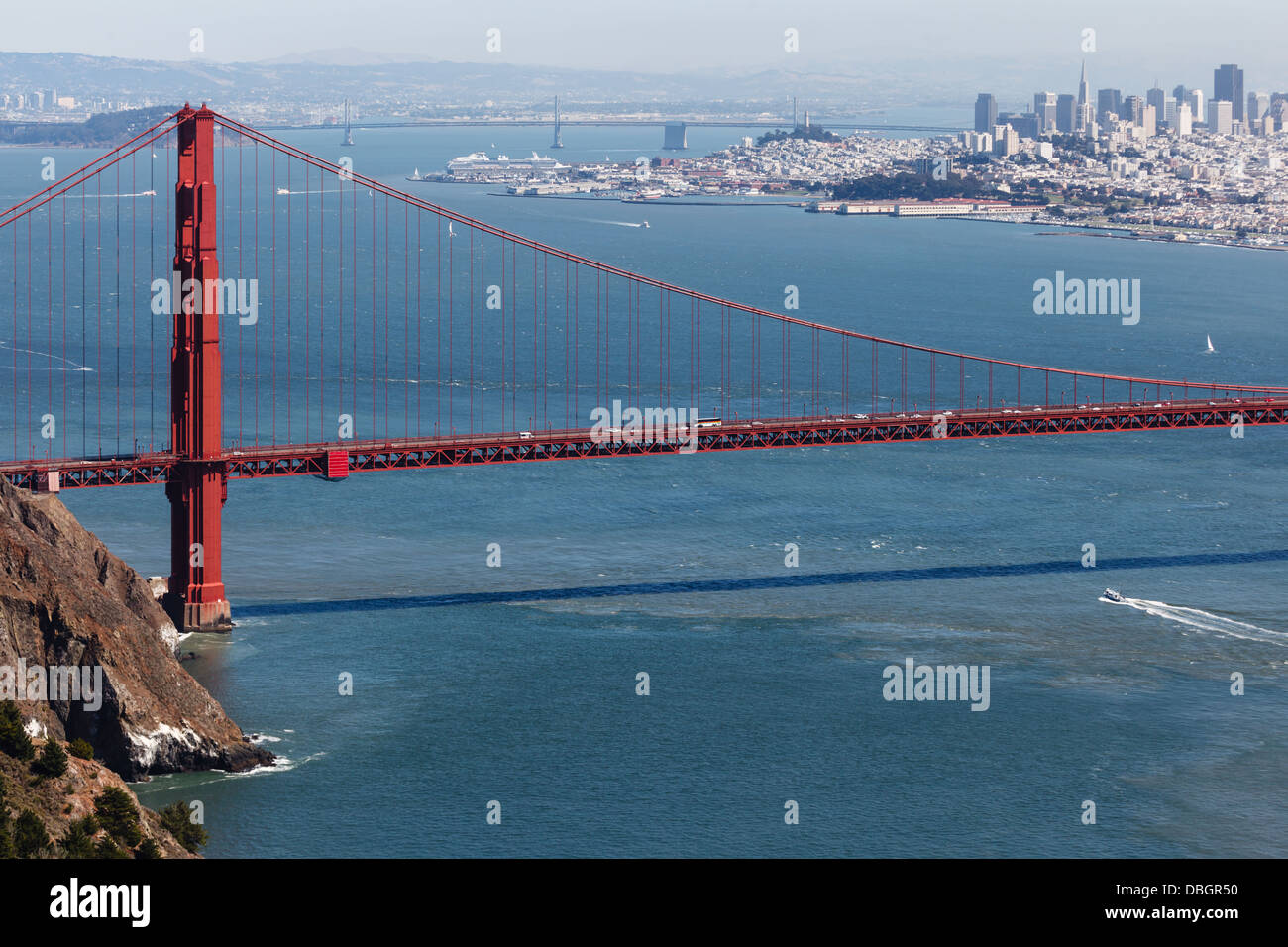 Tower of Golden Gate Bridge and across San Francisco Bay to city from cliffs on a sunny day Stock Photo
