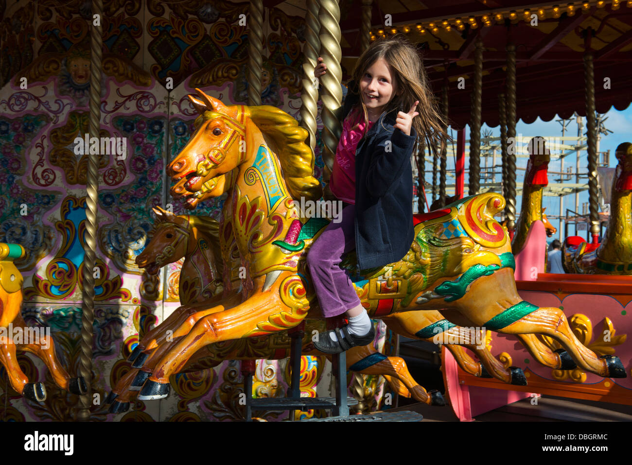 Model released image of a young girl riding on a Merry-go-Round at Portsmouth. Stock Photo