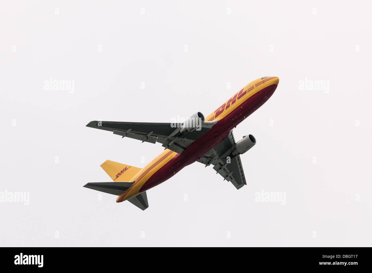 A Boeing 767 owned and operated by ABX Air and in distinctive DHL yellow and red livery takes off from Vancouver International Stock Photo