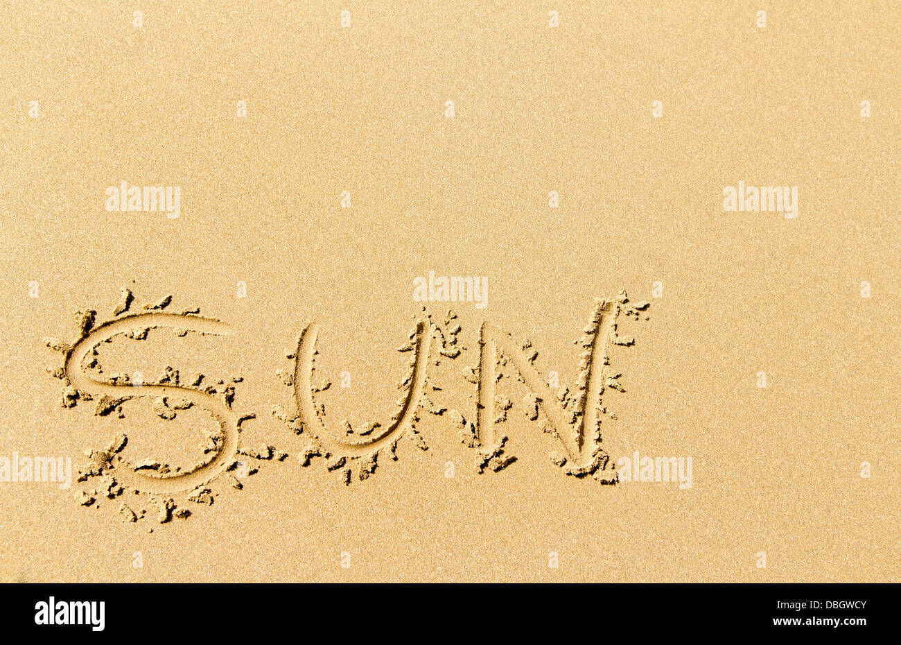 Word sun written on sandy beach Stock Photo - Alamy