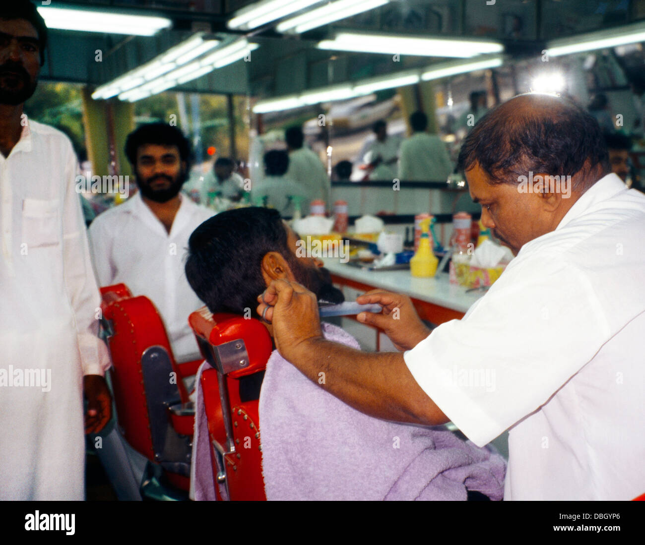 abu Dhabi UAE Al Ain Barber Trimming Man's Beard Stock Photo Alamy
