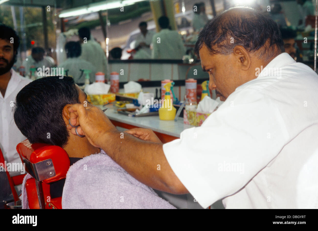 abu Dhabi UAE Al Ain Barber Trimming Man's Beard Stock Photo Alamy