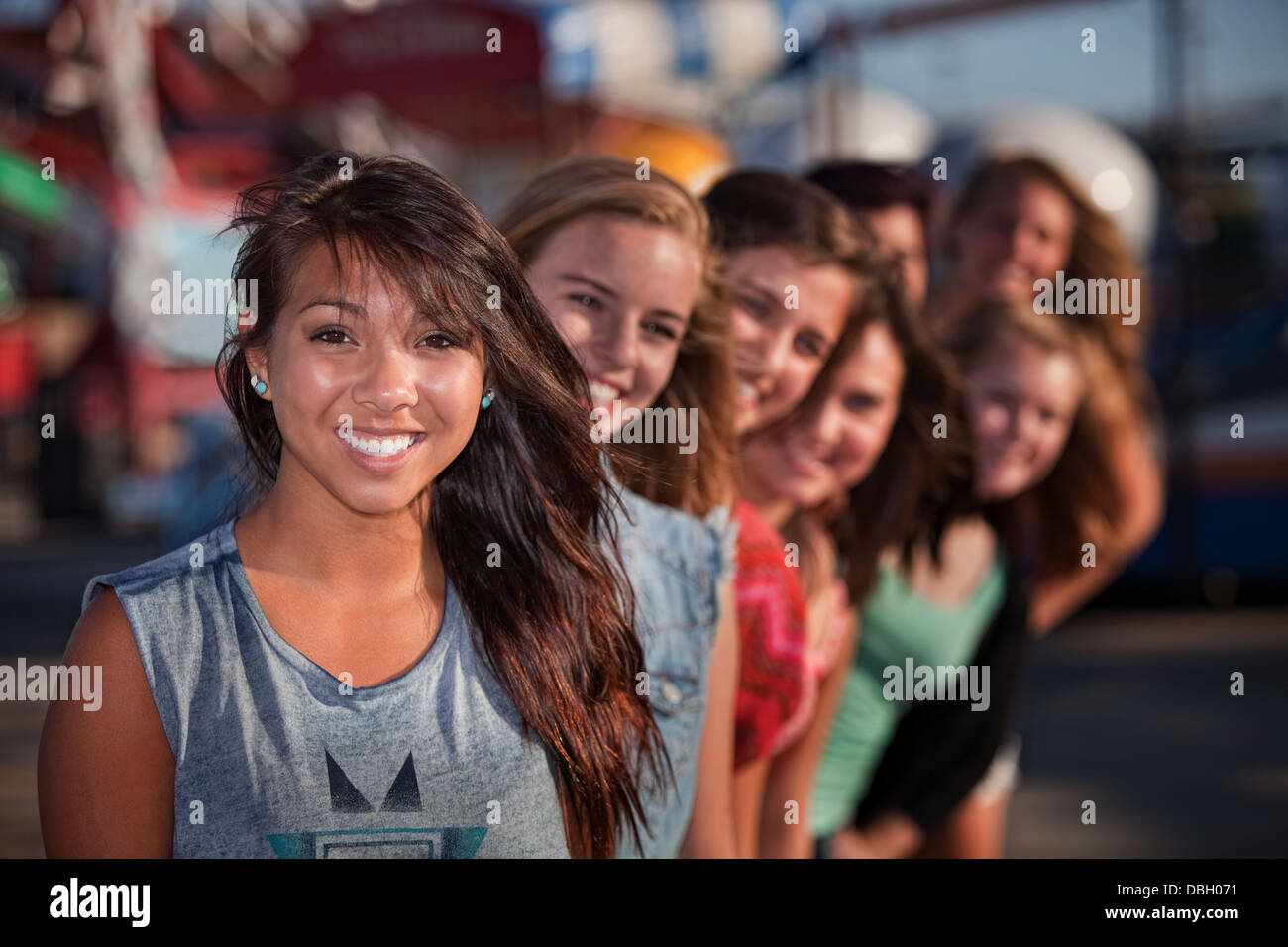 Row of Cute Girls at Theme Park Stock Photo
