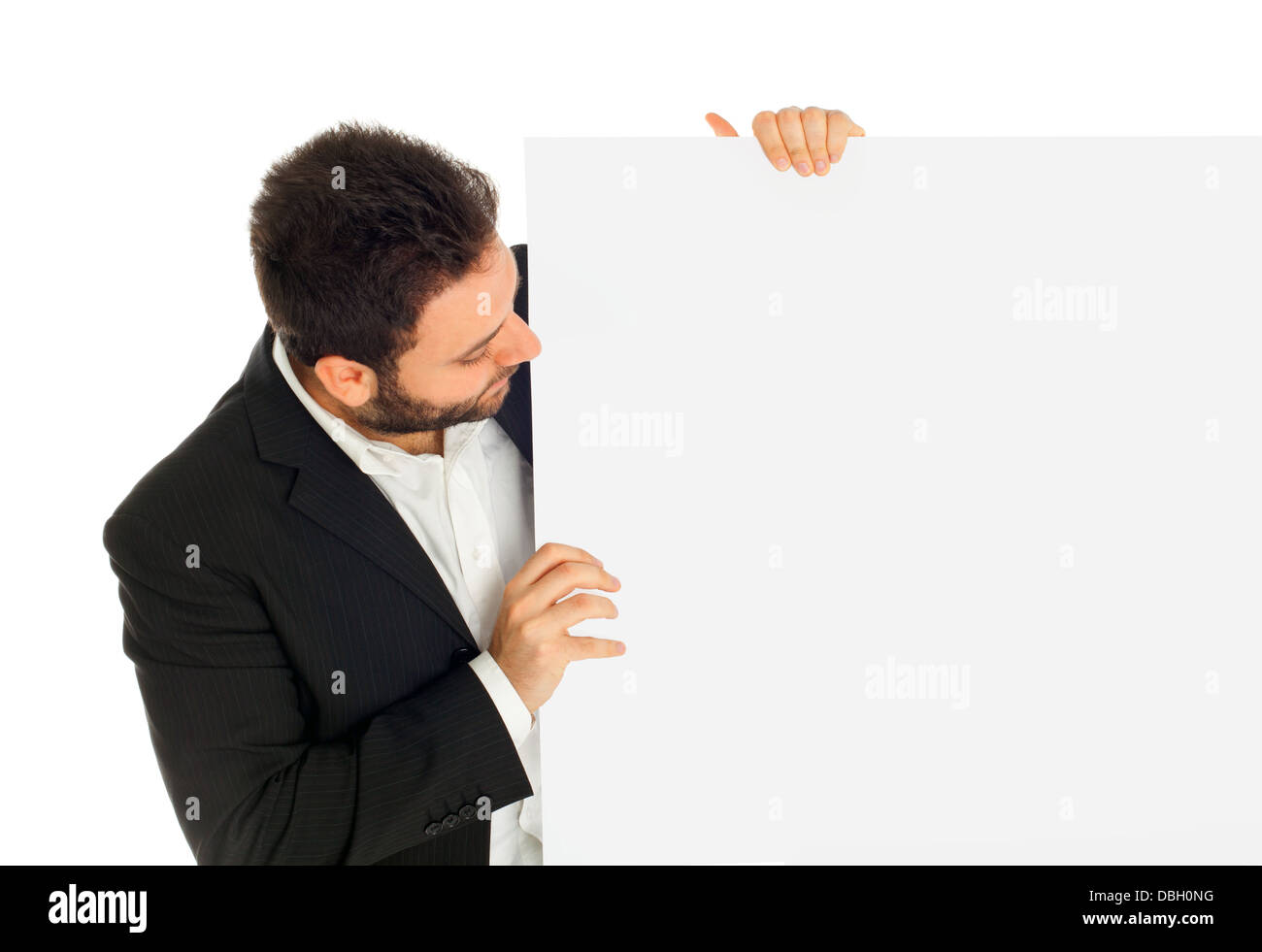 Portrait of a handsome young man looks at a white sign Stock Photo