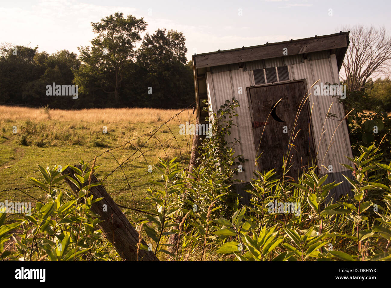 Old leaning outhouse on farm in Lindsay Ontario in the Kawartha Lakes Stock Photo