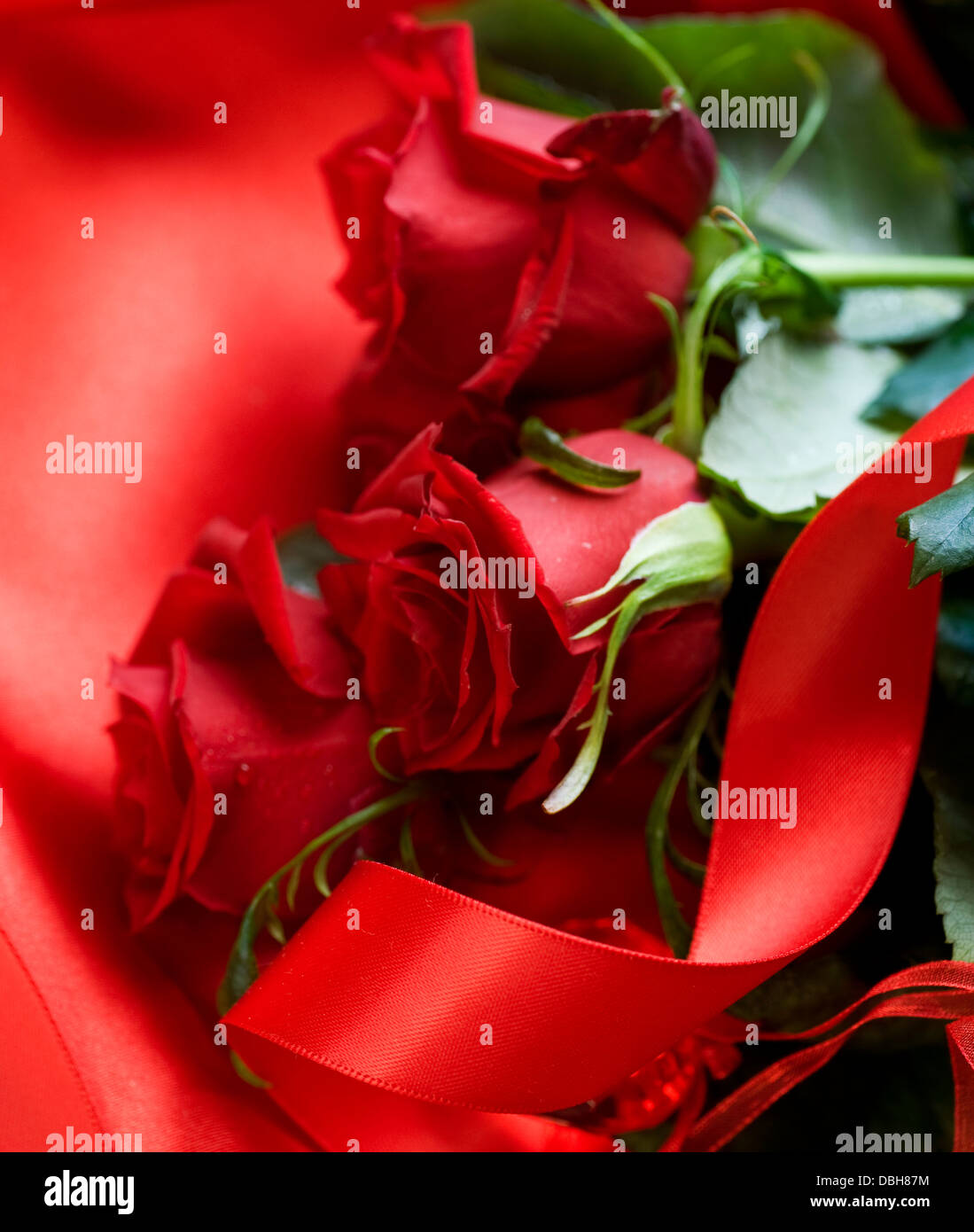 Red Roses bouquet over silk background. Valentine Stock Photo - Alamy