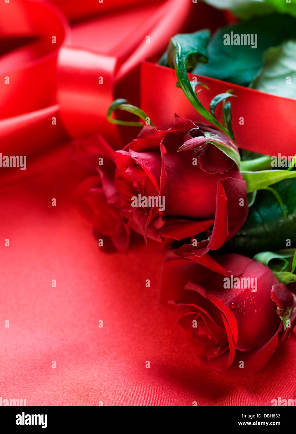 Red Roses bouquet over silk background Stock Photo - Alamy