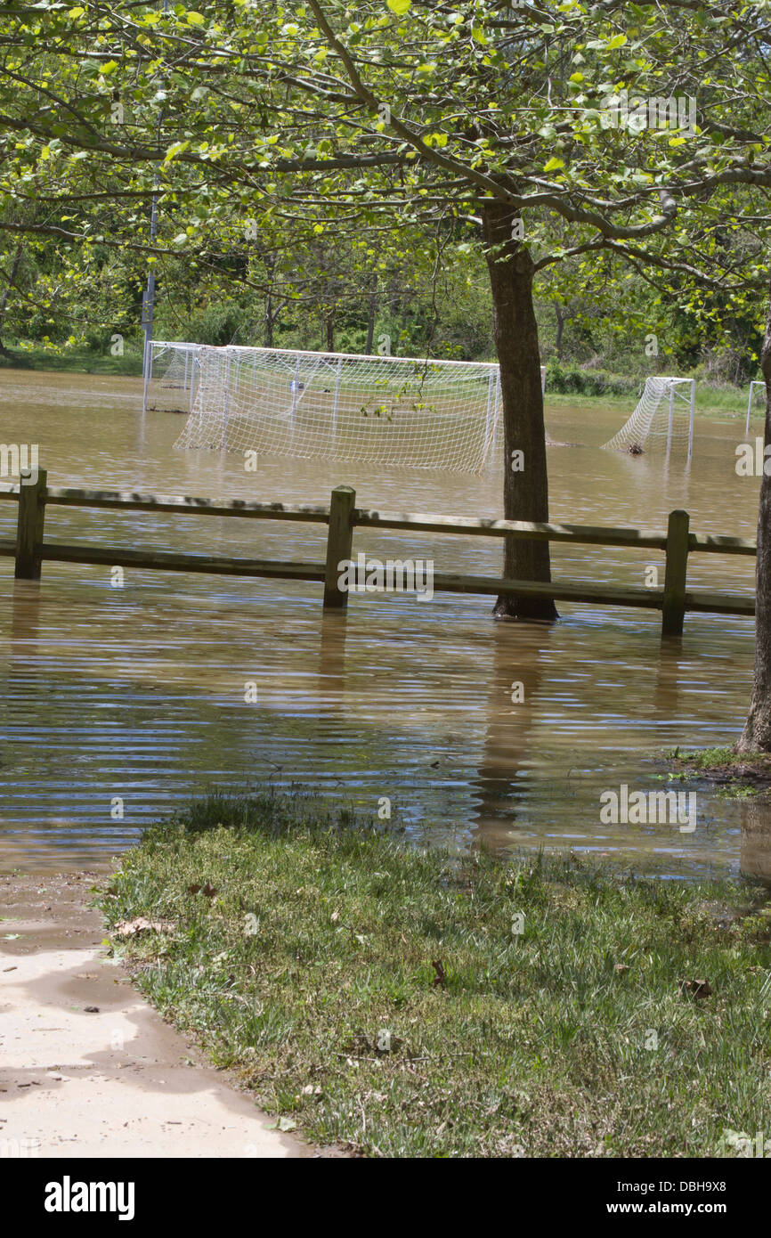 A river flooded soccer field after a spring storm Stock Photo