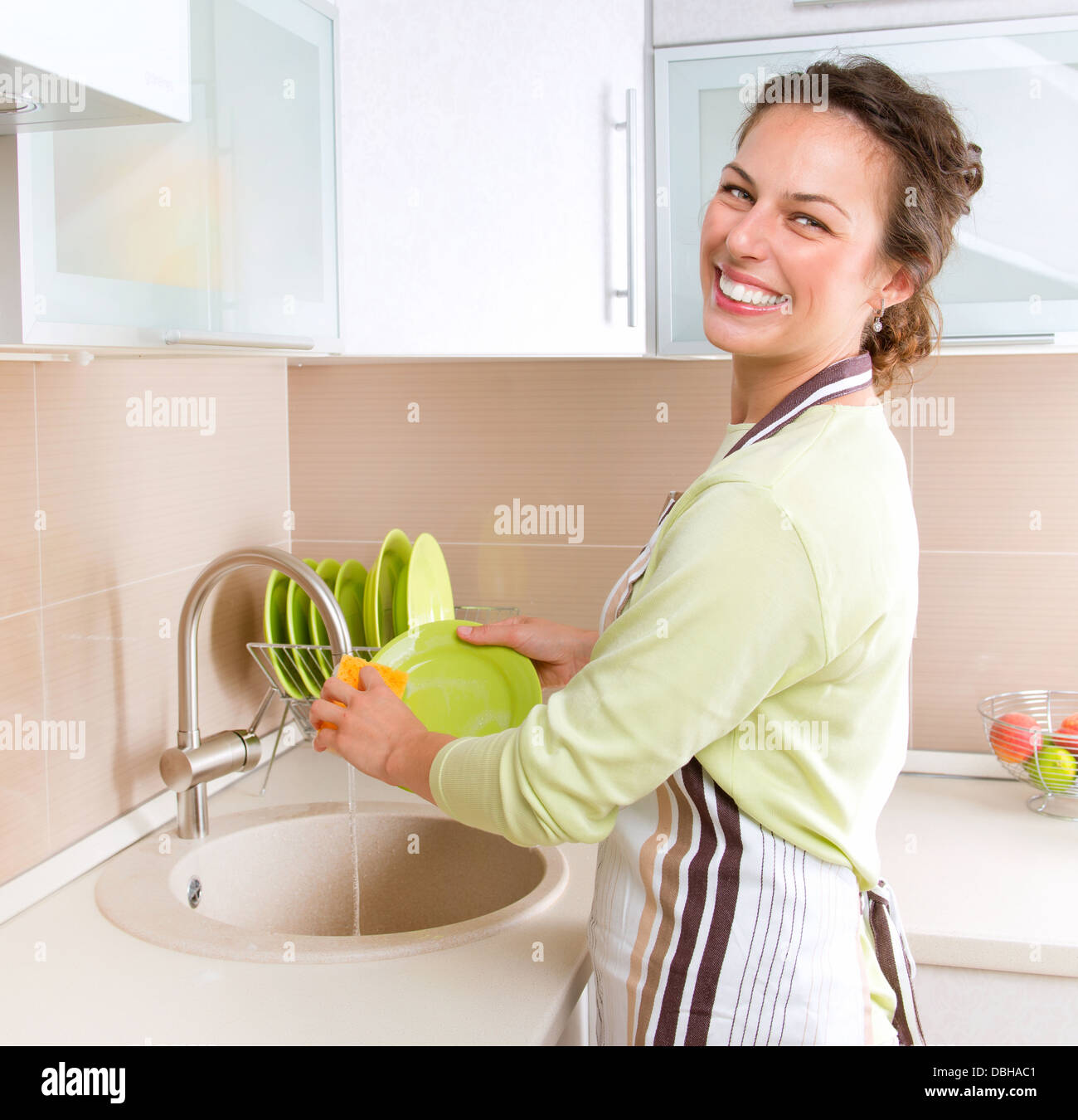 https://c8.alamy.com/comp/DBHAC1/dishwashing-happy-young-woman-washing-dishes-DBHAC1.jpg
