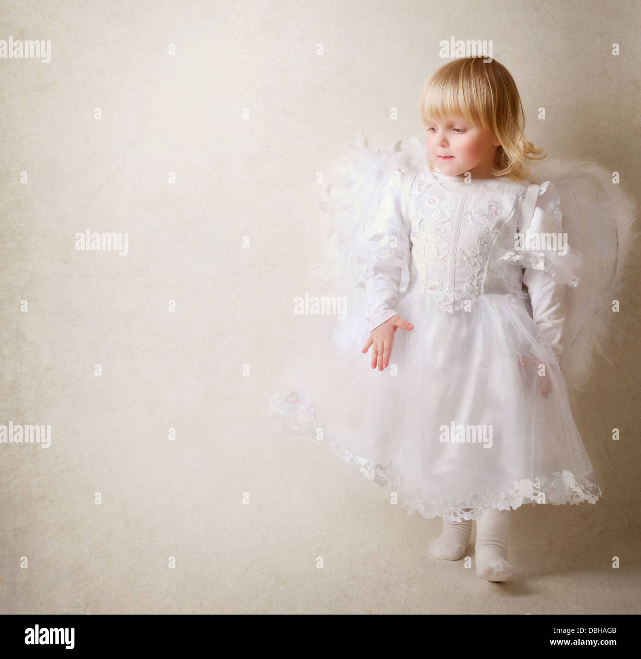 Baby girl in an angel dress Stock Photo