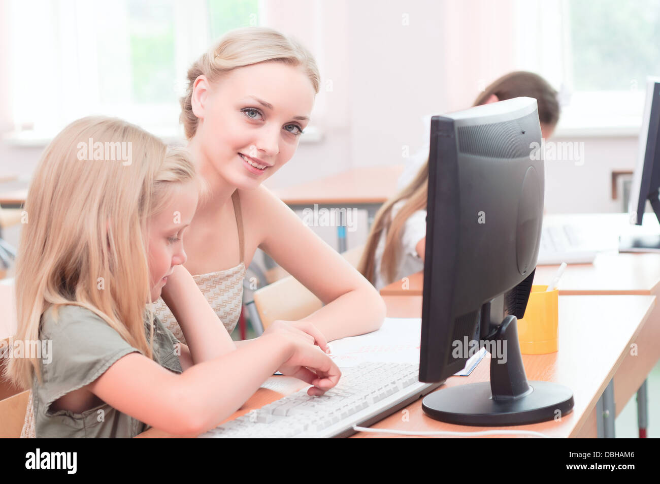 teacher explains the task schoolgirl at the computer Stock Photo - Alamy