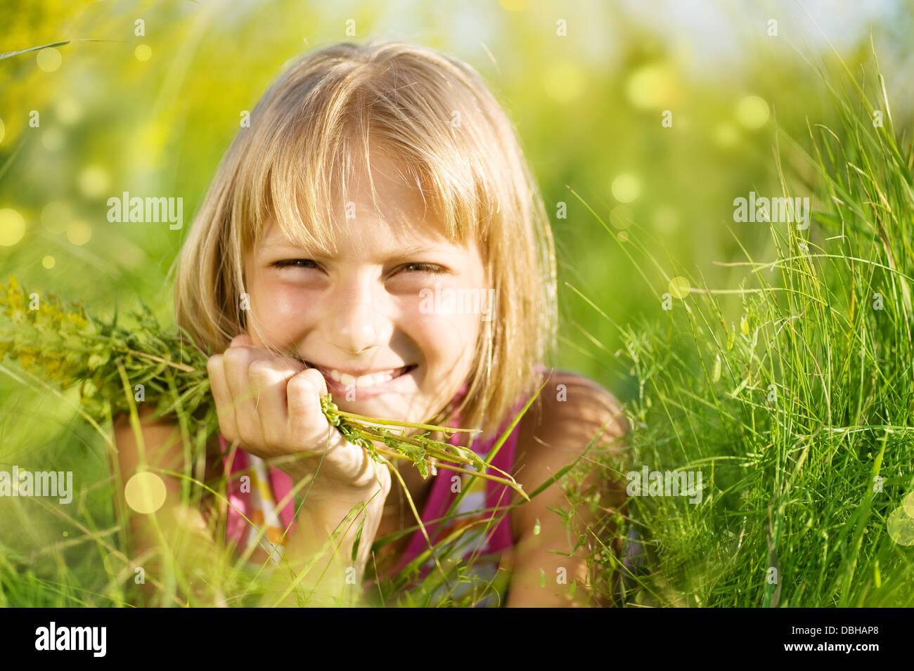 Beautiful Summer Portrait Of Little Girl In The Grass Stock Photo - Alamy
