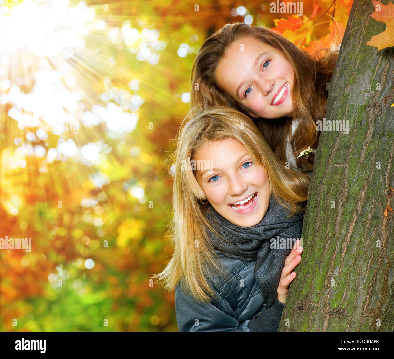Beautiful teenage girls having fun in autumn park outdoor stock photo