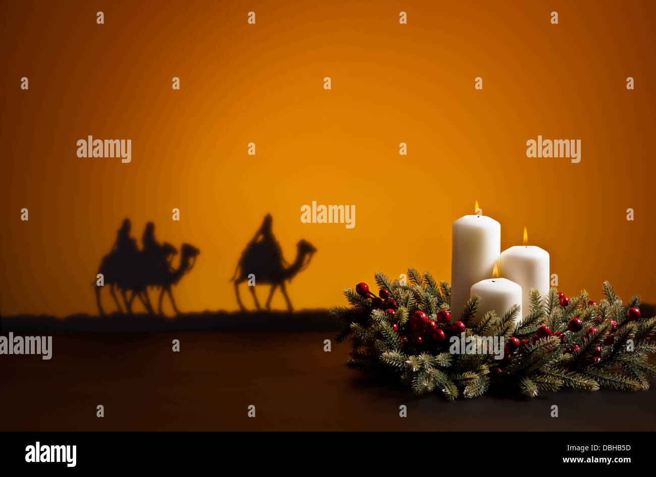 Three wise men on the way to Jesus in Bethlehem and candles Stock Photo