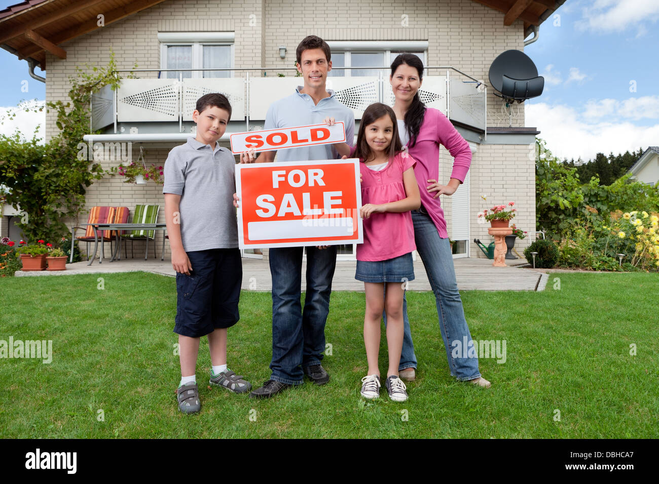 Young family happy to have bought a home Stock Photo - Alamy