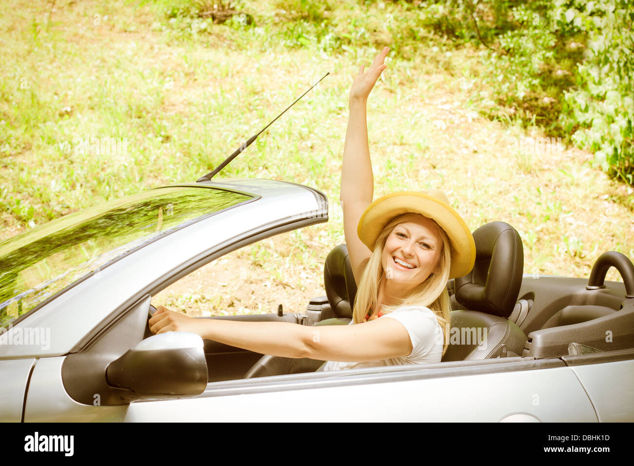 Cheerful beautiful young woman in the car Stock Photo - Alamy
